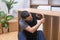 Custom furniture business handyman assembling wooden rack tightening nails