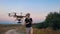 Custom hexacopter flies over a man and flies out of the frame. Slow motion.