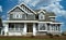 Custom Home Dwelling Residence Large House Front View Exterior Porch Fluffy Clouds