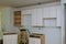 Custom kitchen cabinets in various stages of installation base for island in center