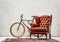 Custom made bicycle, old carpet and luxury retro armchair in room
