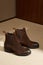 Custom made men`s classic brown suede chelsey shoes in minimalist luxury tailor studio apartment