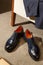 Custom made men`s classic oxford shoes and suit in minimalist luxury tailor studio apartment