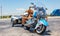 Custom motorbike blue color with trailer, parked outdoors in a sunny spring day. USA