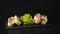 Custom sushi roll in tempura with nori, fresh salmon, tuna, avocado, masago caviar, drizzled with pineapple sauce with