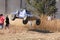 Custom twin seater rally buggy airborne over bump on sand track