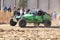 Custom twin seater rally buggy kicking up trail of dust on sand