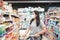 Customer Asian Woman Wearing Face Mask With Shopping Cart in Supermarket Department Store Shop While Choosing and Looking Goods on