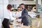 Customer buying a vehicle at car dealership. woman and man handshaking