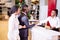 Customer buying a vehicle at car dealership. woman and man handshaking