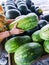 Customer chooses a fresh, ripe, juicy watermelon at a farmers` market