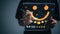 The customer creates a happy face smiling symbol using a digital pen on a futuristic virtual interface screen. The consumer