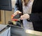 Customer Doing NFC Payment At Checkout Counter