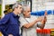 Customer Examining Packed Screwdriver While Vendor