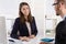 Customer and female financial agent in a discussion at desk.