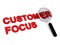 Customer focus with magnifying glass on white
