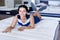 Customer girl is relaxing lying on new mattress before buying it