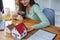 Customer holding a magnifying glass to select a house model, residential inspection concept