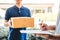 Customer Man signature in clipboard to receive package from professional delivery man at home