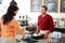 Customer Paying In Coffee Shop Using Touchscreen