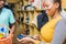 customer paying for items bought in a supermarket with a credit card, black female attendant processing the payment with a mobile