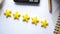 Customer review concept. Rating golden stars on blue background on white paper