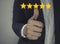 Customer review good rating concept hand pressing five star on visual screen and positive customer feedback testimonial