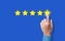 Customer satisfaction Concept. hand Rating five Star on blue background. Satisfied Client and very good Service Review concept