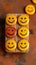 Customer sentiment Smiley faces on wooden buttons convey positive reviews