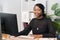 Customer service agent, financial advisor call center employee sits at desk in company in front of computer screen