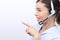 Customer service operator woman with headset pointing