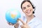 Customer service operator woman with headset smiling, globe