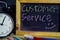 Customer service on phrase colorful handwritten on blackboard