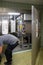 Customer service representative repairs a steam sterilizer in a hospital
