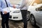 Customer shake hand with auto insurance agents after agreeing to