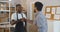 Customer and small business owner handshake in storehouse