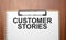 Customer Stories text on white paper on the wood table