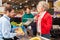 Customer at supermarket checkout looks over cashier