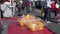 Customer tasting orange slices at outdoor farmers market