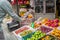 A customer uses smart phone to pay at a fruit market stand with Qr code