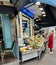 Customer waits at outdoor counter of fishmonger on Montmartre, Paris