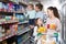 Customers with children selecting sweet dairy products in hyper