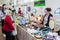 Customers examine a table of jewelry at a fossil and mineral show