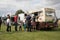 Customers queuing and buying ice cream from ice cream van at a festival