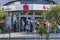 Customers queuing in front of a bank branch, some of whom are wearing a face mask because of Covid-19