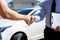 Customers shake hand with car insurance agents to enter into friendly terms and conditions