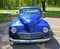 Customised Blue Plymouth 1947 Coupe isolated in car park.