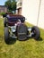 Customized classic lowrider hot rod roadster with exposed engine, big tires