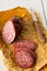 Cut beef salami on white wooden table with cutting knife