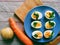 cut boiled eggs decorated with parsley, potatoes and carrots